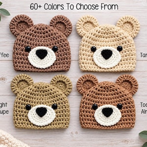 May include: Four crochet bear hats in coffee, tan, light taupe, and toasted almond colors. Each hat features two round ears, two black circular eyes, and a white circular muzzle with a black heart-shaped nose. Text reads 60+ Colors To Choose From.