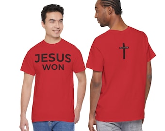 May include: Red t-shirts with black text and graphics. One shirt displays "JESUS WON" on the front. The other shirt has a black cross and the text "Romans 6:23" on the back. The shirts are worn by two people.