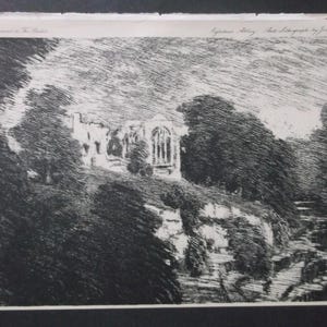 Op de afbeelding: Een zwart-wit lithografische prent met de ruïnes van Egleston Abbey tussen bomen op een heuvel. Het kunstwerk bevat dichte arceringen en lijnen voor textuur, met bovenaan de tekst: Supplement to The Studio, Egleston Abbey, Auto Lithograph by Joseph Pennell.