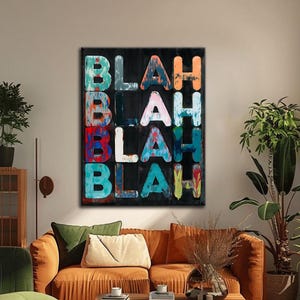 May include: Abstract art piece with the word "BLAH" repeated vertically in colorful, textured letters against a black background. The letters are in shades of blue, orange, red, and white. The artwork is displayed in a living room setting.