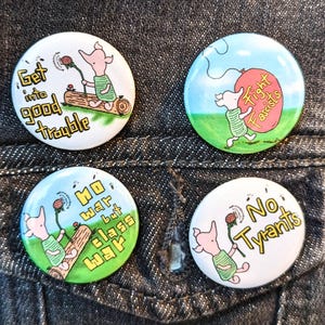 May include: A white ceramic mug with a black handle and the text "But First, Coffee" in a black, bold font. The mug is sitting on a white surface. The mug appears to be empty.