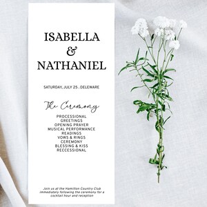 May include: A wedding ceremony program featuring the names "Isabella & Nathaniel" in black. The program details the ceremony and is complemented by white flowers with green stems.
