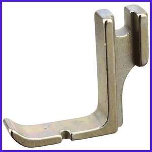 May include: A silver metal sewing machine foot with a curved base and a vertical arm with a slot.