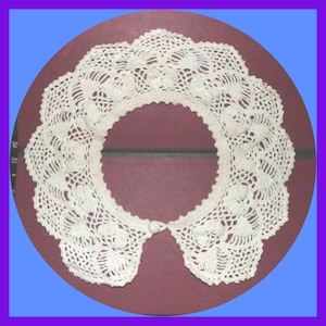 May include: A white crocheted collar with a scalloped edge and a button closure.