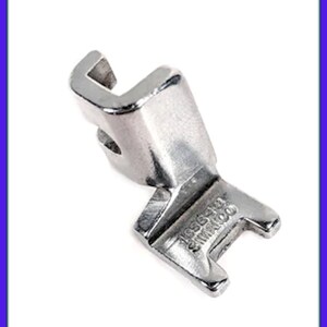 May include: A silver sewing machine foot with a J-shaped opening and the text "1635118 SHIMRA1000" on the bottom.