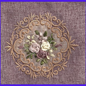 May include: A close-up of a delicate floral embroidery design on a light pink fabric. The design features a cluster of pink, white, and light purple roses surrounded by a decorative, swirling, gold-colored border.