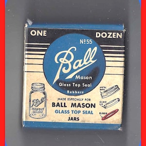 May include: A vintage Ball Mason jar box with a blue and white design. The box features the Ball logo, jar illustrations, and text indicating "Glass Top Seal" and "Rubbers." The box is labeled "One Dozen" and "No. 55."