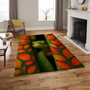 May include: A rectangular area rug featuring a green snake peering out from a dark opening. The rug's border is adorned with orange and red leaves against a dark green background. The rug is placed on a wooden floor.