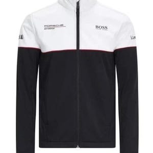 May include: A black, white, and red zip-up jacket with a high collar. The jacket features the "PORSCHE MOTORSPORT" and "BOSS" logos. The top half is white, the middle has a red stripe, and the bottom is black.