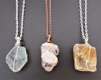 Your choice of raw fluorite, clear quartz point, or honey calcite