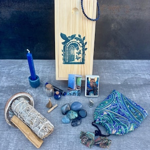 May include: A white ceramic mug with a black handle and the text "But First, Coffee" in a bold, black font. The mug is set against a plain white background, highlighting its simple design.