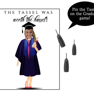 May include: A graduation-themed game with a cartoon illustration of a graduate in a cap and gown, holding a diploma. The text reads "THE TASSEL WAS worth the hassel!" and "Pin the Tassel on the Graduate game!" Includes three black tassels.