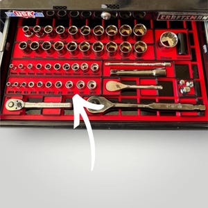 May include: A Craftsman tool set organized in a black toolbox with a red interior. The set includes various sockets, ratchets, and extensions. The sockets are arranged by size, with measurements in inches. The toolbox is labeled with the Craftsman logo.
