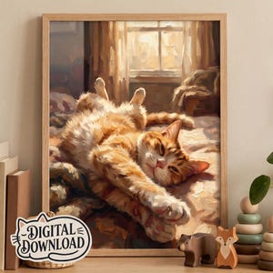 May include: A framed digital art print featuring an orange tabby cat lying on its back on a bed, stretching its paws towards the viewer. The scene is set in a sunlit room with a window in the background. A small sign reads DIGITAL DOWNLOAD.