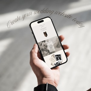 May include: A black smartphone displaying a wedding website template with a cream-colored background, featuring black text and black-and-white photographs. The screen displays the text Create your wedding website today at the top.