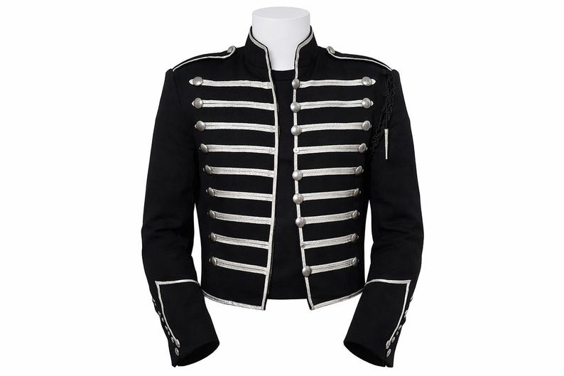 May include: A black military-style jacket featuring silver-toned braided trim and metallic buttons arranged in horizontal rows across the front. The jacket includes a high collar, structured shoulders, and silver piping details on the cuffs.