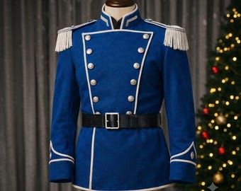 May include: A royal blue military-style jacket featuring white piping, silver-toned buttons in a double-breasted arrangement, white fringe epaulets on the shoulders, and a black belt with a silver buckle cinched at the waist.