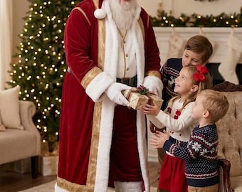 May include: Santa Claus in a red and white velvet coat with gold trim hands a wrapped gift to a young child. Two other children stand nearby, and a large brown sack filled with presents sits on the floor in front of them in a room.