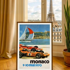 May include: Framed vintage poster for the Monaco Grand Prix, featuring race cars, a sailboat, and the text "monaco 9-10 mai 1970". The poster is 30x40 inches and is displayed in a room with a view of the Eiffel Tower.