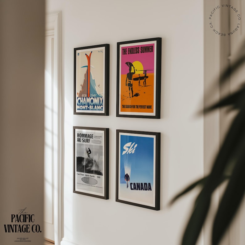 May include: Four framed vintage travel posters on a white wall. The posters feature ski and surf themes, with text including "CHAMONIX MONT-BLANC", "THE ENDLESS SUMMER", "HOMMAGE AU SURF", and "CANADA". The Pacific Vintage Co. logo is in the corner.