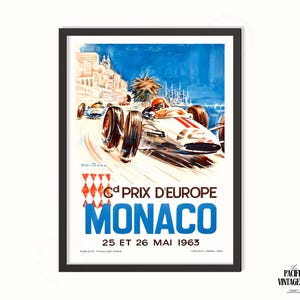 May include: Vintage poster print of the 6th Prix D'Europe Monaco race from 1963. The artwork features a white race car with red accents speeding along a coastal road, with the text "MONACO" in large blue letters.