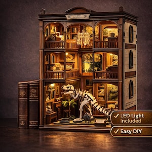 May include: DIY Book Nook Kit featuring a Dinosaur Museum. The miniature model includes a dinosaur skeleton, museum exhibits, and LED lighting. The kit is designed to be easy to assemble and includes two faux books.