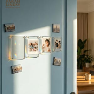 May include: Clear acrylic photo frames and city skyline magnets are displayed on a light blue door. The frames hold family photos. The magnets feature the New York and Los Angeles skylines. The brand name "FARAH LINDSY" is visible.