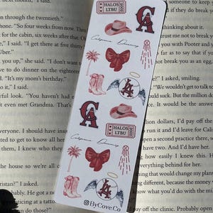 May include: A rectangular white bookmark featuring repeating maroon and pink illustrations including cowboy hats, bows, palm trees, cowboy boots, baseballs with wings and halos, and tickets labeled HALOS LTBU 2002. The text California Dreaming is present.