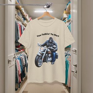 K&ouml;nnte beinhalten: Cremefarbenes T-Shirt mit dem Text "You Talkin' To Me?" &uuml;ber einem Bild eines Gorillas auf einem Motorrad. Der Gorilla tr&auml;gt eine Lederjacke und Jeans. Das Motorrad ist silber und schwarz.