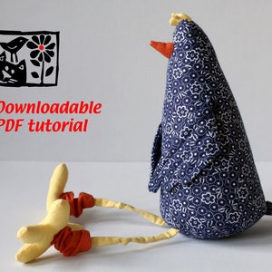 May include: A handmade fabric chicken doll with a blue floral pattern body, yellow legs, and an orange beak. The image includes a black and white illustration of a bird, cat, and flower, with the text "Downloadable PDF tutorial".