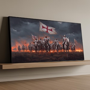 May include: A framed canvas print showing a medieval battle scene. Knights on horseback charge, carrying flags with red crosses. The background features a fiery landscape under a dark, stormy sky. The artwork is displayed on a wooden shelf.