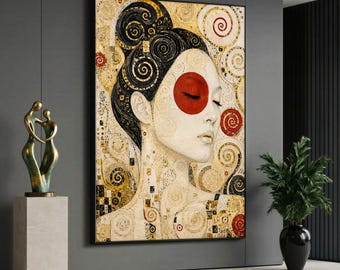 May include: A rectangular wall art print featuring a stylized portrait of a person with dark hair in a high bun, a prominent red circle on the cheek, and intricate gold and black swirling patterns against a cream background.