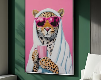 May include: A framed art print featuring a leopard wearing pink sunglasses and a white hooded robe, holding a pink mug. The leopard's fur is spotted, and the background is a solid pink.
