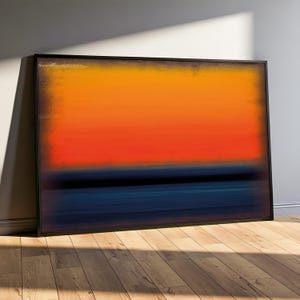 May include: Abstract art print in a black frame, showcasing a gradient of colours. The artwork transitions from orange at the top, through red, to a deep blue at the bottom. The framed print is leaning against a wall.