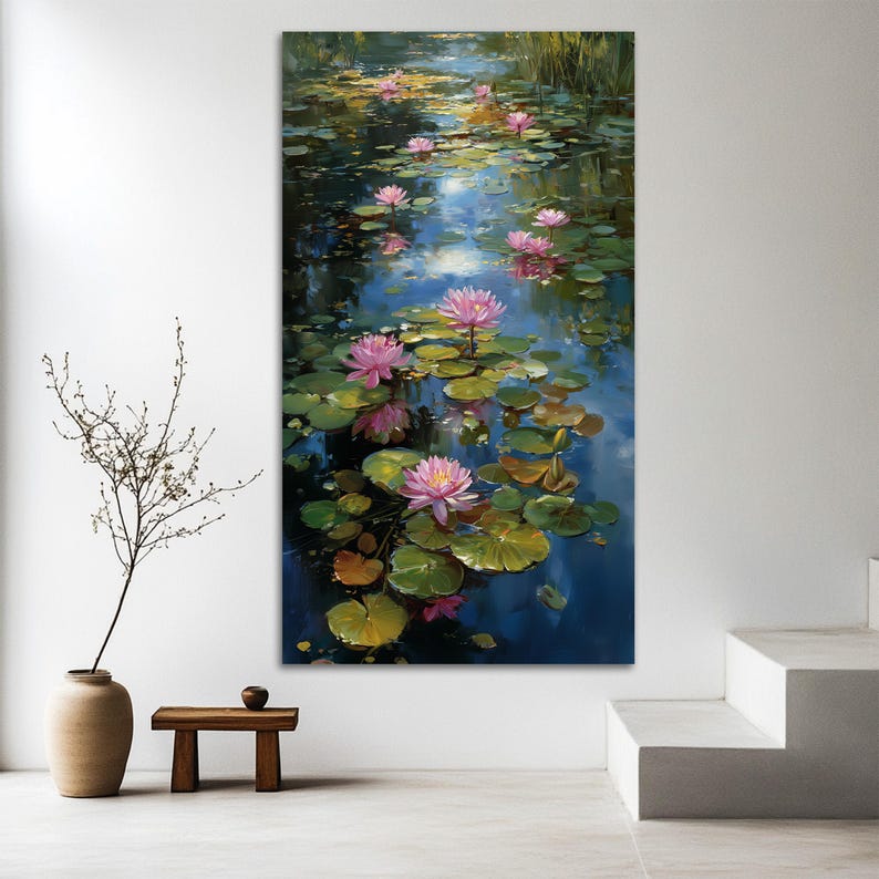 May include: A vertical canvas print of a serene pond scene. Pink water lilies float on the water's surface, surrounded by lily pads. The water reflects the sky and the flowers, creating a tranquil and colorful artwork.
