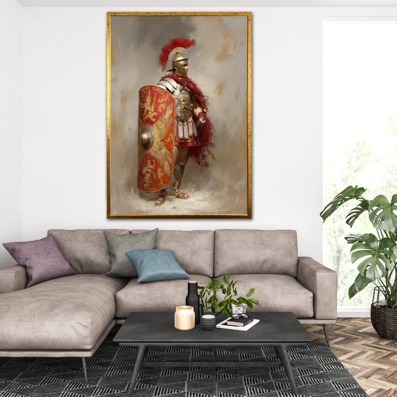 May include: A framed painting of a Roman soldier in full armor, holding a shield. The soldier wears a red plume, a silver helmet, and a red cape. The shield is red and gold with a detailed design. The painting has a gold frame and is displayed above a gray sofa.