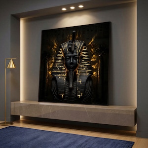May include: A framed artwork featuring a stylized depiction of an Egyptian pharaoh. The pharaoh's bust is rendered in black and gold, with intricate details and a regal headdress. The artwork is displayed on a neutral-toned shelf, with a gold floor lamp and a blue rug in the foreground.