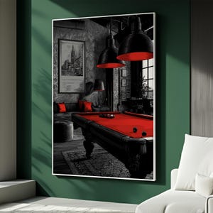 May include: A framed print depicting a pool room with a red pool table, black and white decor, and red cushions. The room is illuminated by black pendant lights with red interiors. The artwork is mounted on a green wall.