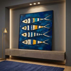 May include: A square wall art piece featuring four stylised fish arranged horizontally. Each fish has a striped pattern in shades of blue, white, and yellow against a deep blue background. The artwork is framed in a thin black border.