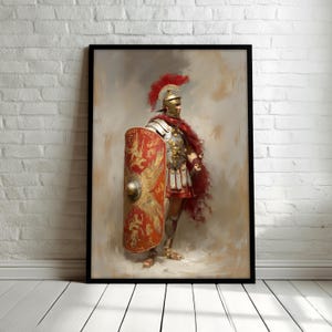 May include: Framed artwork depicting a Roman legionary in full armor. The soldier stands with a red shield and cape, a golden helmet with a red plume, and detailed silver and gold armor. The background has a soft, painterly effect.