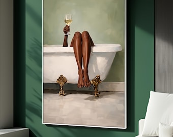 May include: A framed artwork depicts a person relaxing in a white clawfoot bathtub, holding a glass of white wine. The artwork features dark skin tones and gold accents, set against a soft green background. The artwork is a modern, elegant piece.