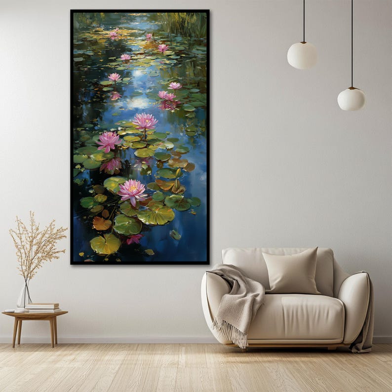 May include: A vertical rectangular wall art print featuring a pond scene with vibrant pink water lilies and green lily pads floating on dark blue water. The painting captures light reflections on the water surface with a black frame.