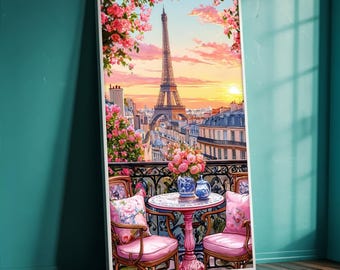 May include: A framed watercolor painting of a Parisian balcony scene. The Eiffel Tower is visible in the background, with pink flowers and a table and chairs in the foreground. The painting has a white frame and is set against a teal wall.