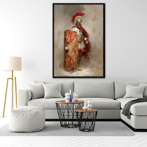 May include: A framed print of a Roman soldier in full armor, holding a shield. The soldier wears a red plume helmet, a red cape, and a breastplate. The shield is red and gold with a detailed design. The artwork has a painterly style.