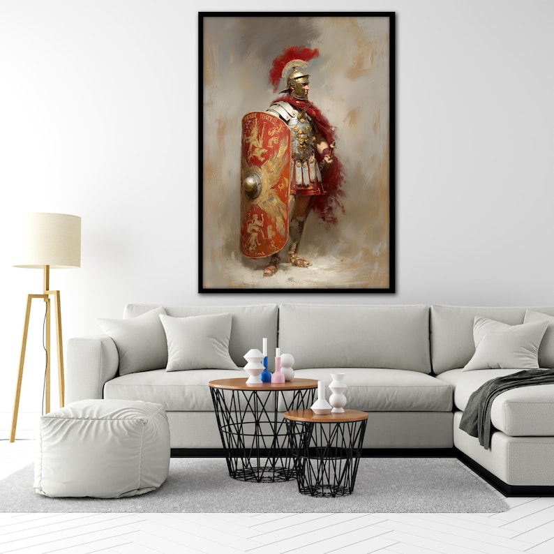 May include: A framed print of a Roman soldier in full armor, holding a shield. The soldier wears a red plume helmet, a red cape, and a breastplate. The shield is red and gold with a detailed design. The artwork has a painterly style.