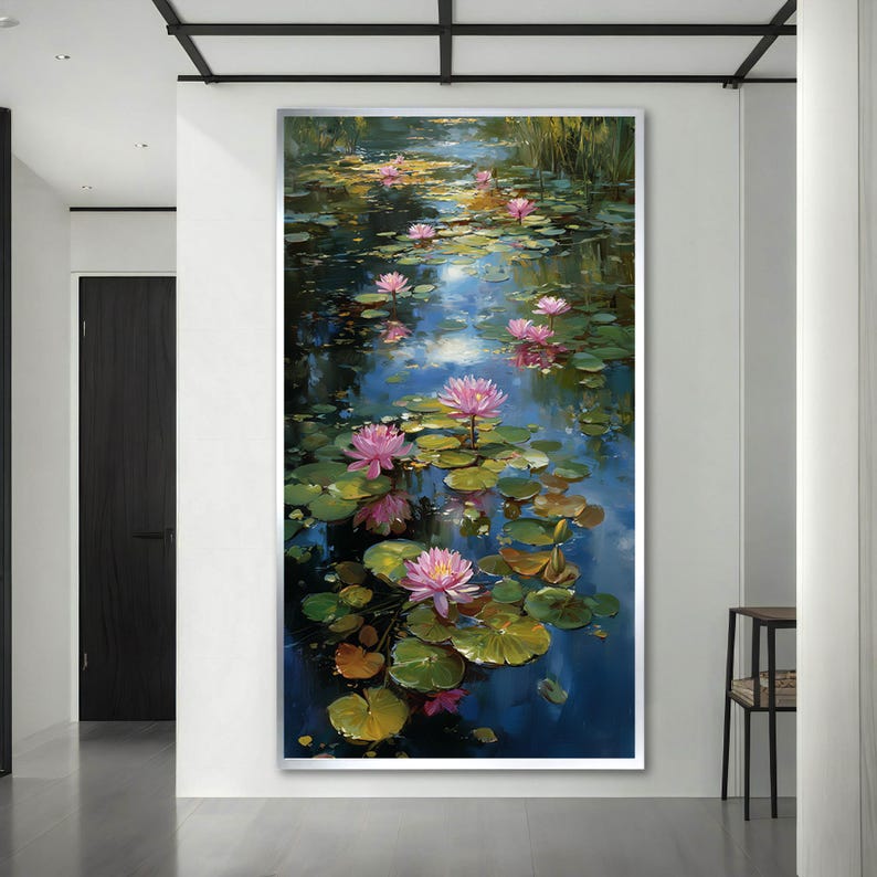 May include: A vertical wall art print featuring an oil painting of a pond filled with vibrant pink water lilies and green lily pads. The water reflects deep blue and golden light, creating a serene scene with multiple blooming flowers.