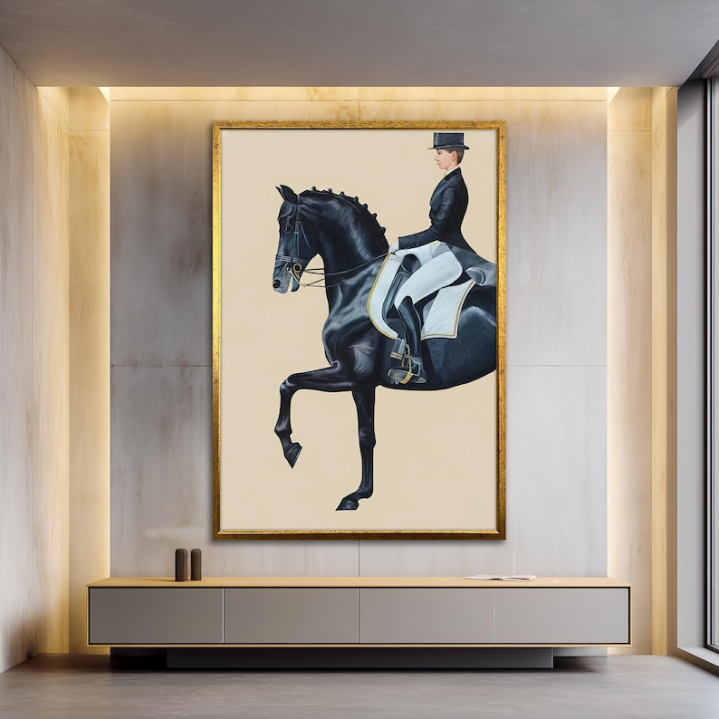 May include: A framed artwork depicts a black horse in a dressage pose, ridden by a person in formal attire. The painting has a gold frame and a neutral background, creating a classic and elegant aesthetic.