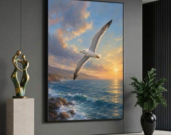 May include: A large rectangular wall art print featuring a painting of a white seagull in flight over a deep blue ocean at sunset. The sky is filled with soft orange, yellow, and blue clouds above a rocky coastline and rolling waves.