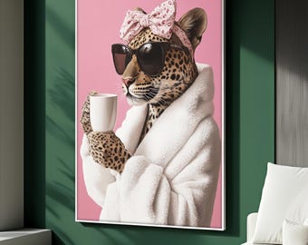 May include: A framed art print featuring a leopard wearing sunglasses, a pink bow, and a white robe, holding a white mug. The background is pink, and the frame is white. The artwork is displayed on a green wall.