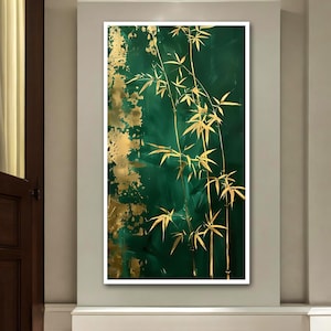 May include: An abstract painting featuring gold bamboo stalks and leaves against a deep emerald green background. Gold paint splatters add texture and contrast to the artwork. The painting is framed in a white border.